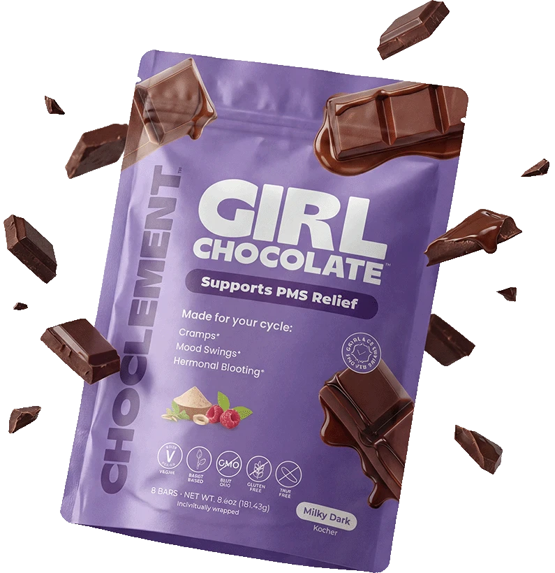 Girl Chocolate kit — chocolate pouch, pink heating pad, tumbler, and silk scrunchie nestled in tissue paper.